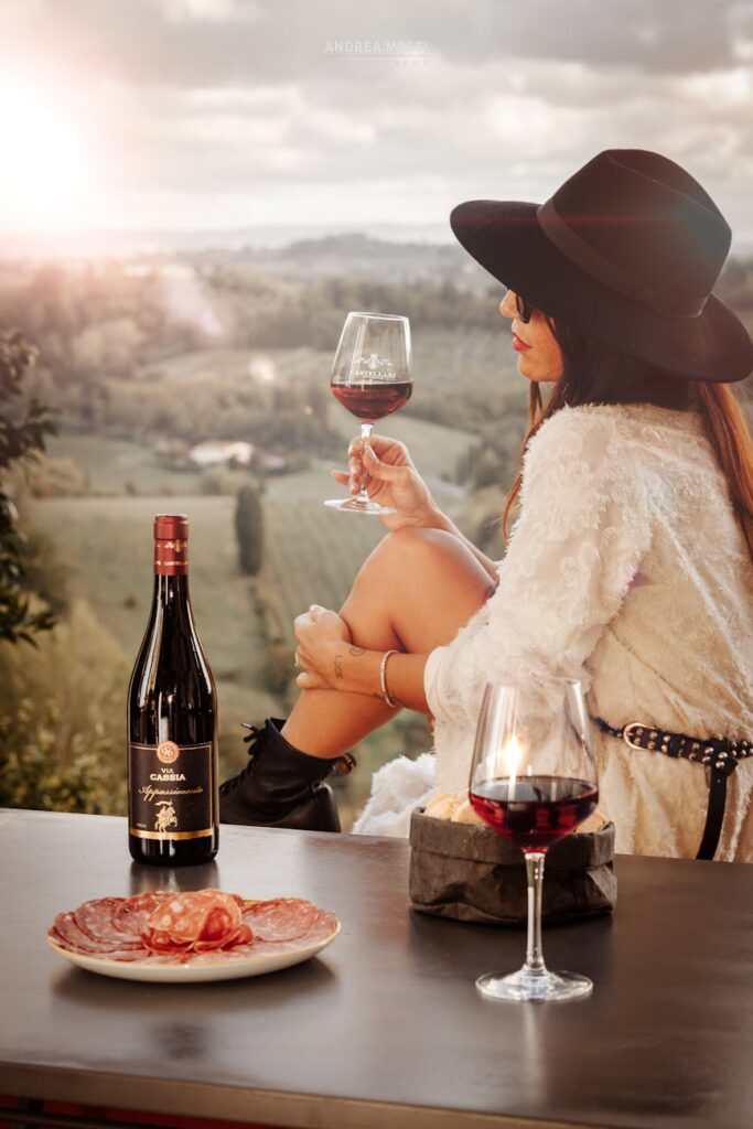 Woman Exploring Italy vineyards during the September shoulder season, woman drinking red wine in a vineyard