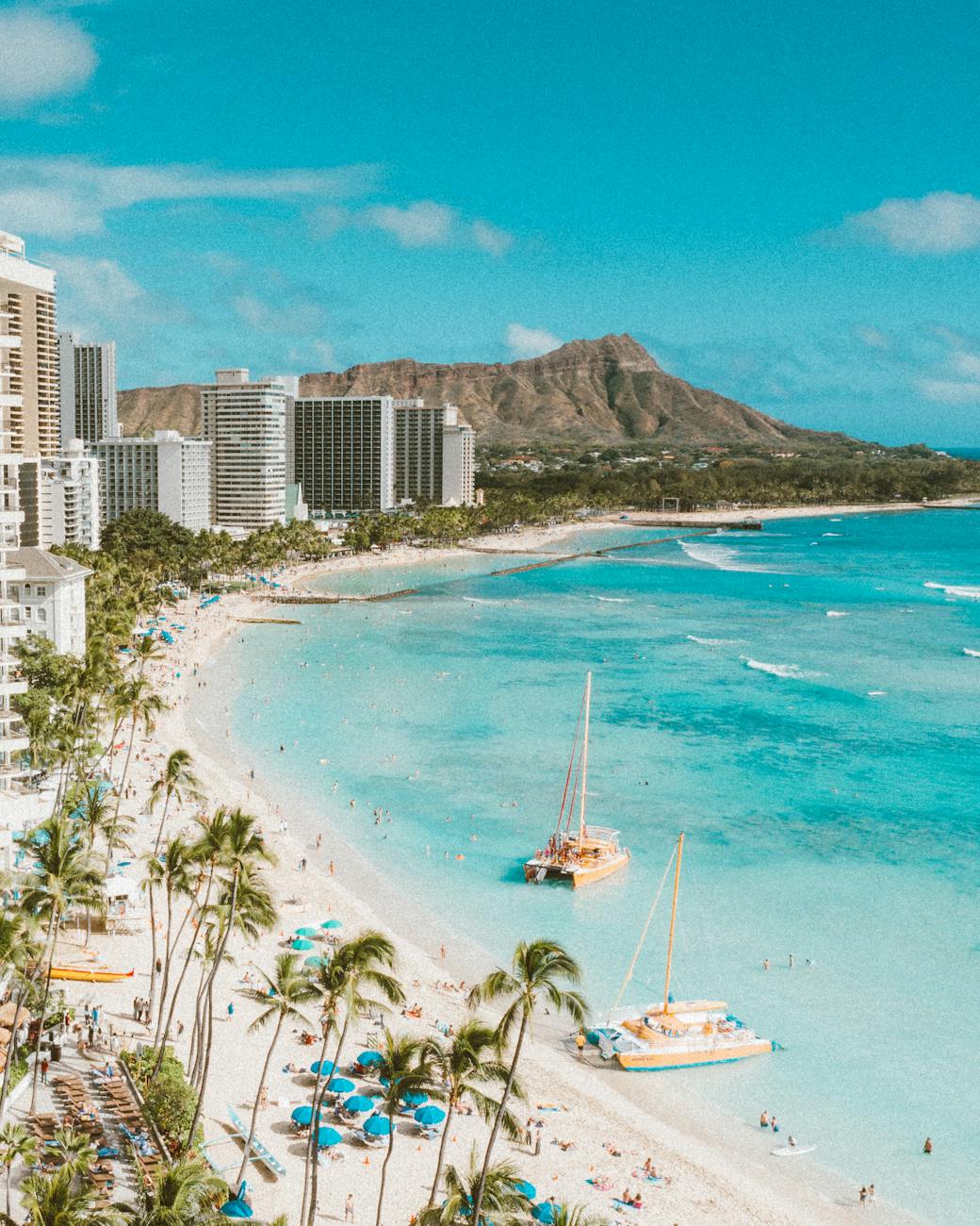 Oahu family spring break destination with kids swimming and catamarans at Waikīkī Beach