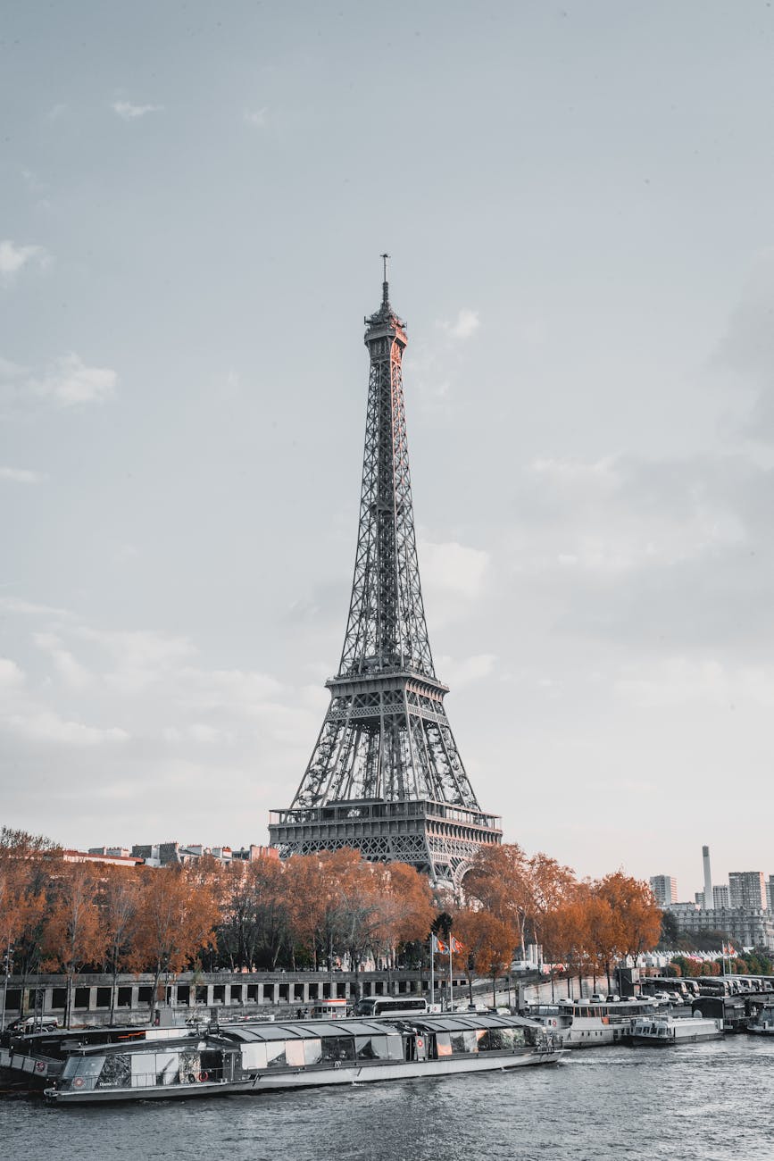 Eiffel Tower in Paris framed by golden fall leaves during shoulder season travel in September